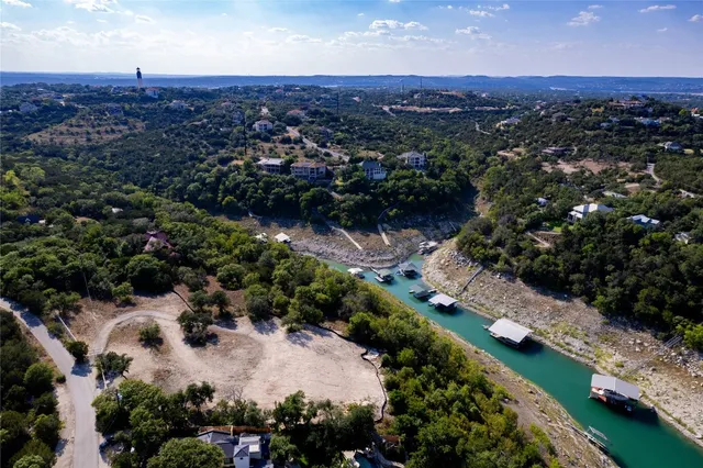an aerial view of residential houses with outdoor space and trees
