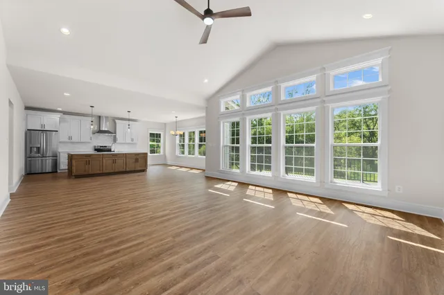 a view of a kitchen with a sink and a large window