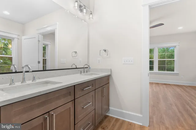 a bathroom with a double vanity sink and a mirror