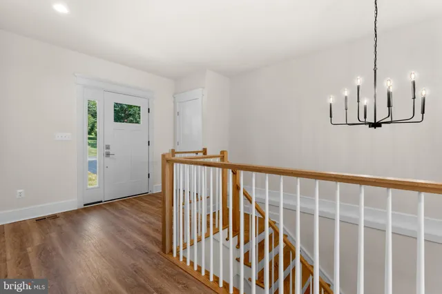a view of hallway with wooden floor