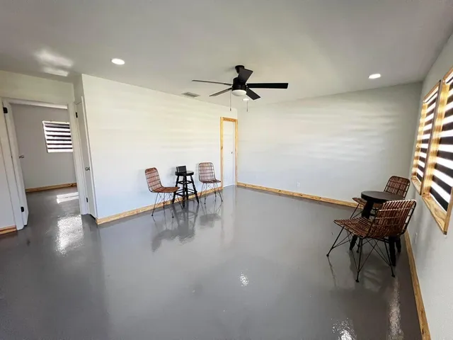 a view of a work space with furniture and wooden floor
