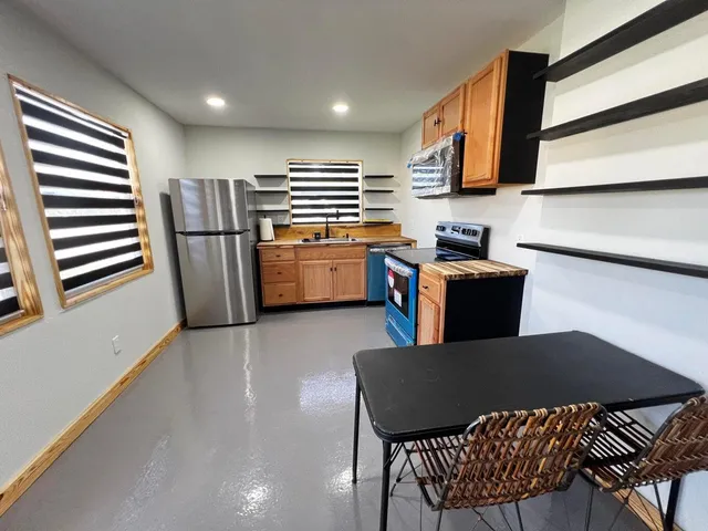 a view of a dining room with furniture and a window