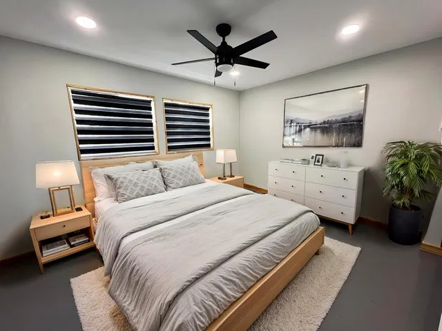 a bedroom with a bed and a chandelier