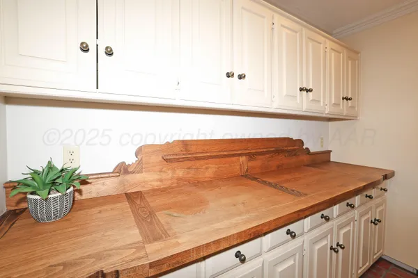 a kitchen with granite countertop a stove a sink and a refrigerator