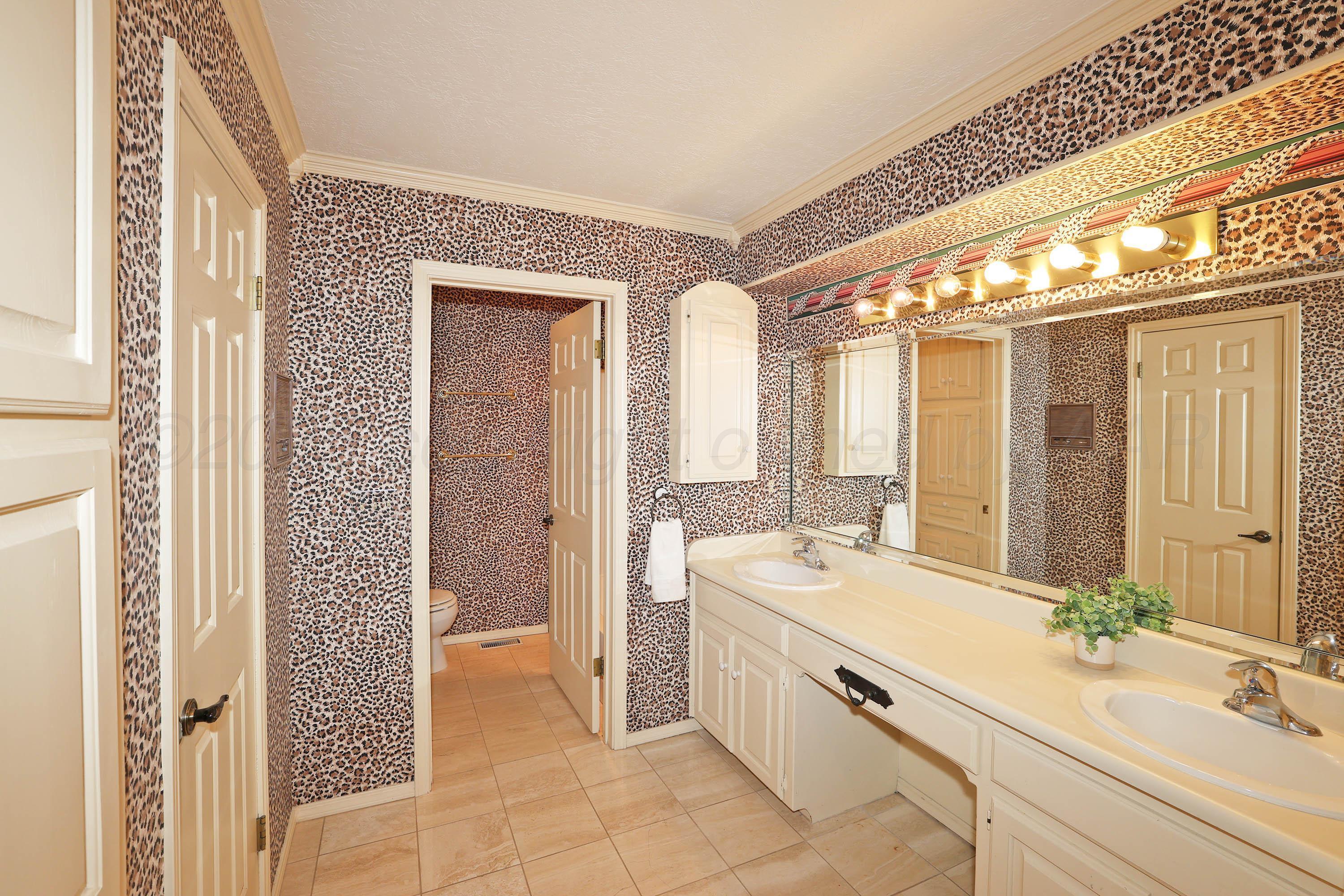 1615 South Bryan Street, Unit 19 Amarillo, TX 79102 - Photo 21 of 53 a spacious bathroom with a double vanity sink a mirror and a bathtub