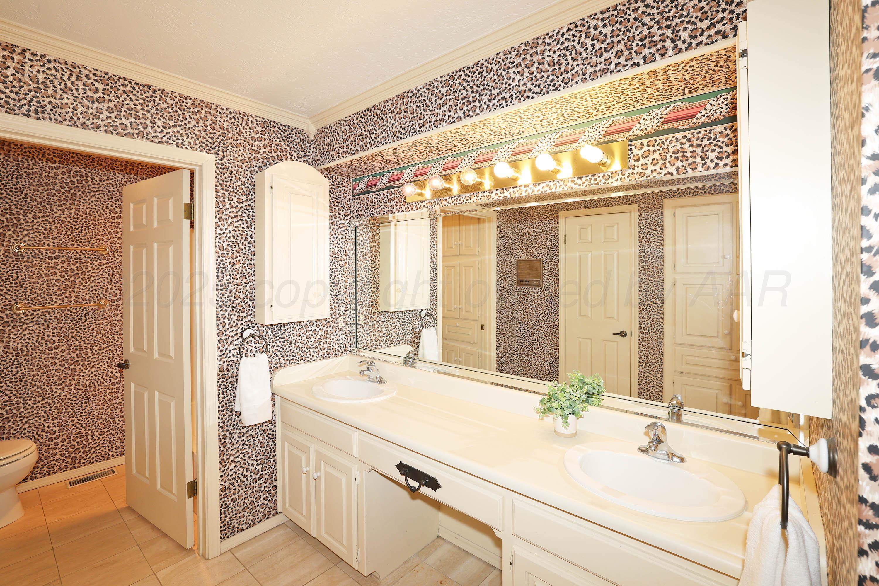 1615 South Bryan Street, Unit 19 Amarillo, TX 79102 - Photo 23 of 53 a bathroom with a double vanity sink and a mirror