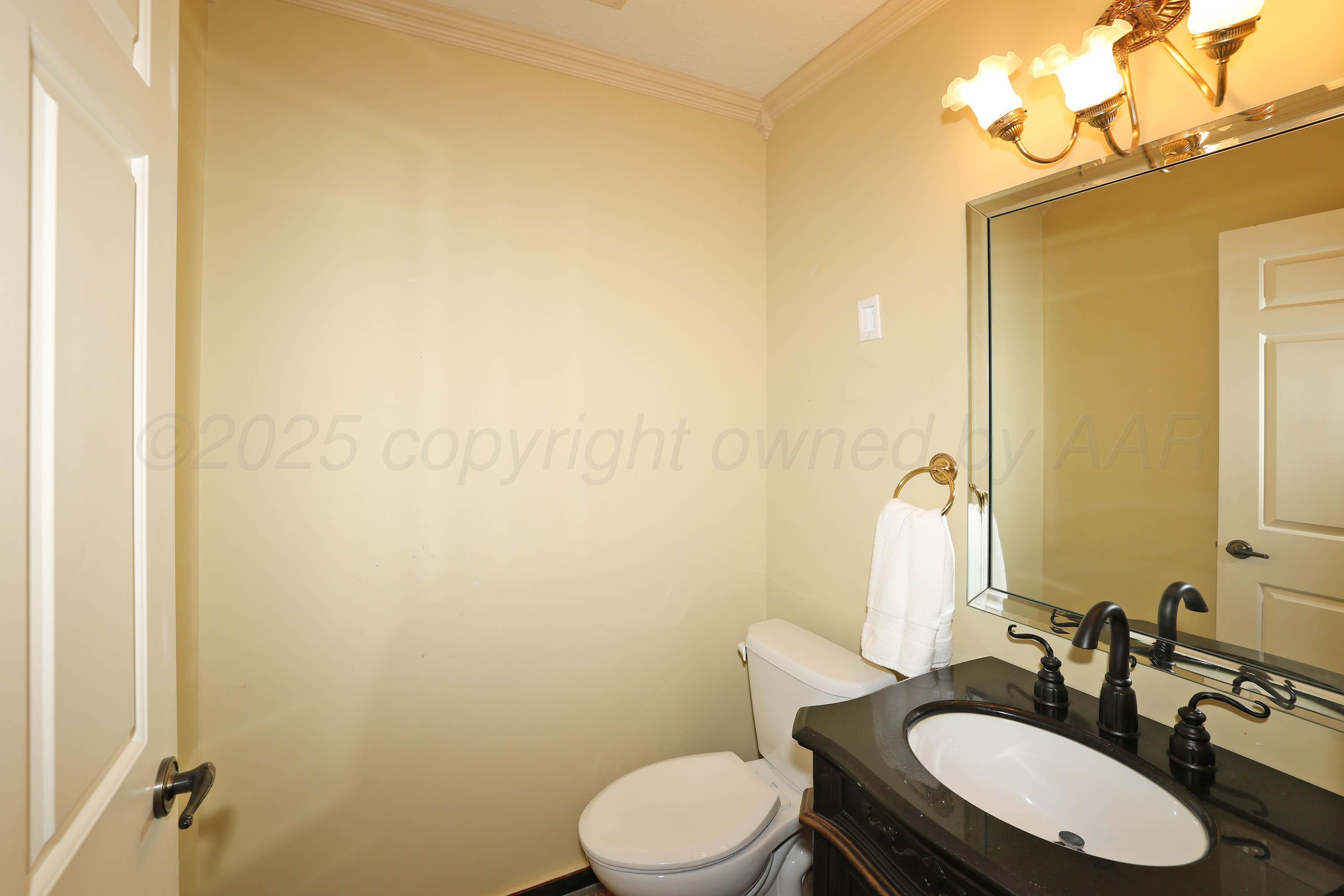 1615 South Bryan Street, Unit 19 Amarillo, TX 79102 - Photo 28 of 53 a bathroom with a sink vanity mirror and toilet
