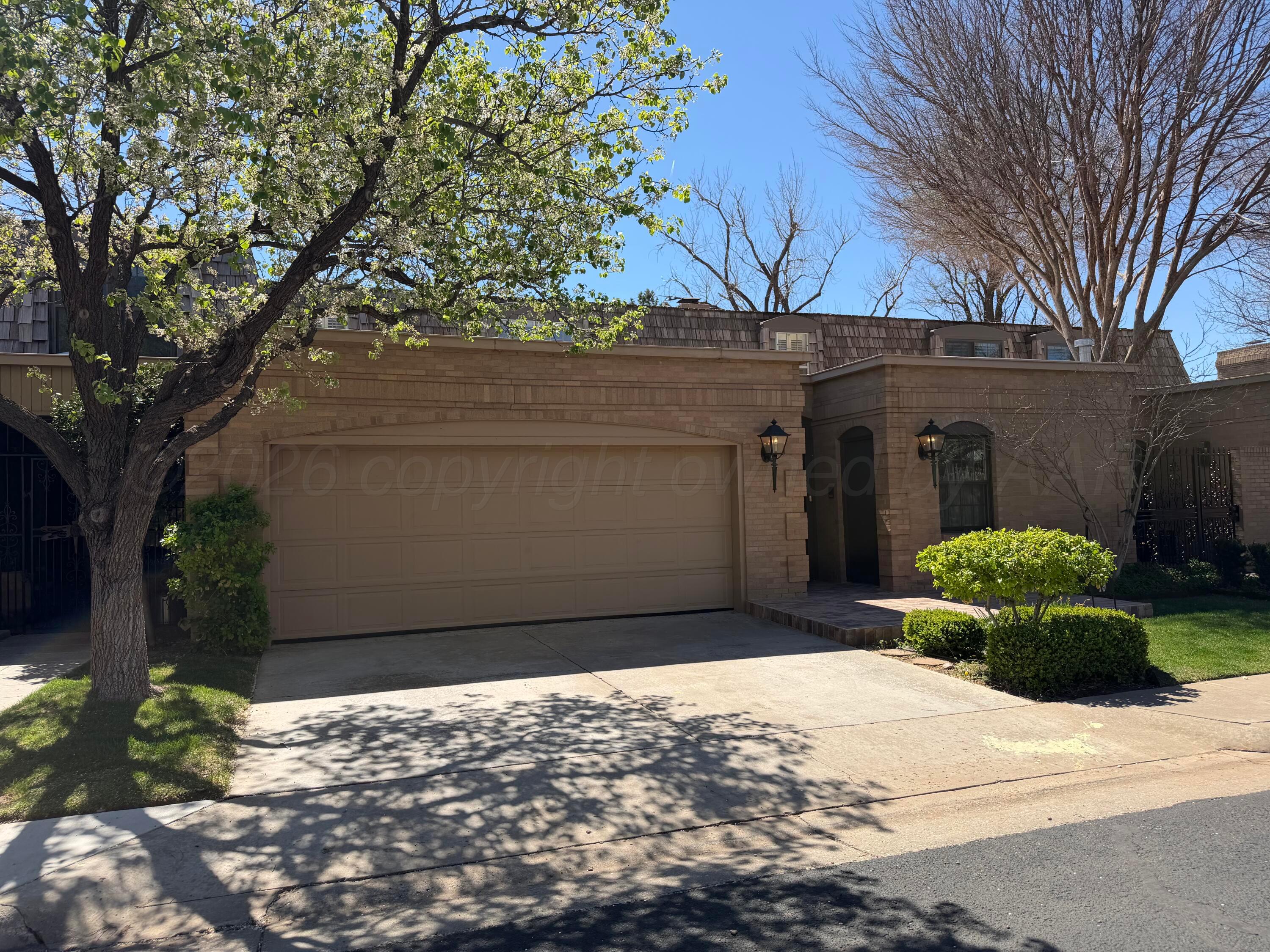 1615 South Bryan Street, Unit 19 Amarillo, TX 79102 - Photo 52 of 53 a front view of a house with a yard and garage