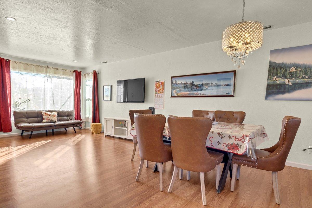 965 Portola Drive Del Rey Oaks, CA 93940 - Photo 7 of 23 a view of a dining room with furniture a chandelier and wooden floor