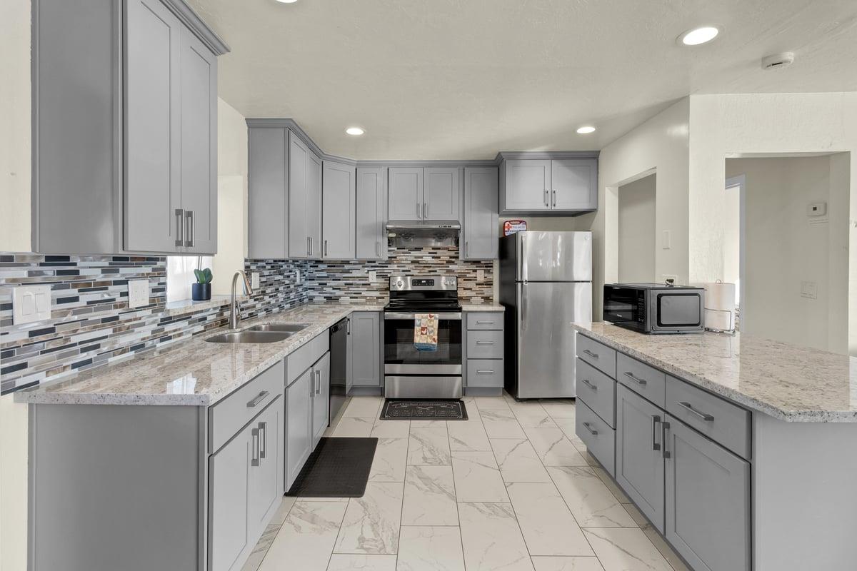 965 Portola Drive Del Rey Oaks, CA 93940 - Photo 9 of 23 a kitchen with kitchen island granite countertop a stove sink and refrigerator