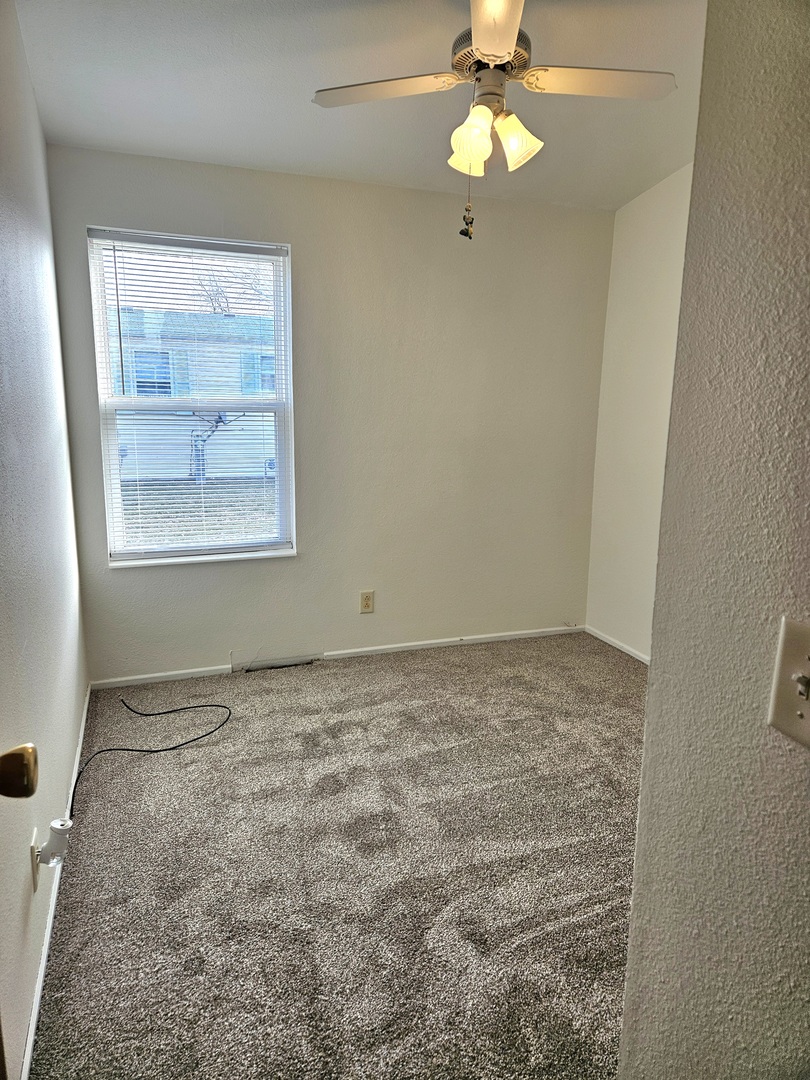 120 B Cardinal Lane Sandwich, IL 60548 - Photo 14 of 15 an empty room with a window and a fan