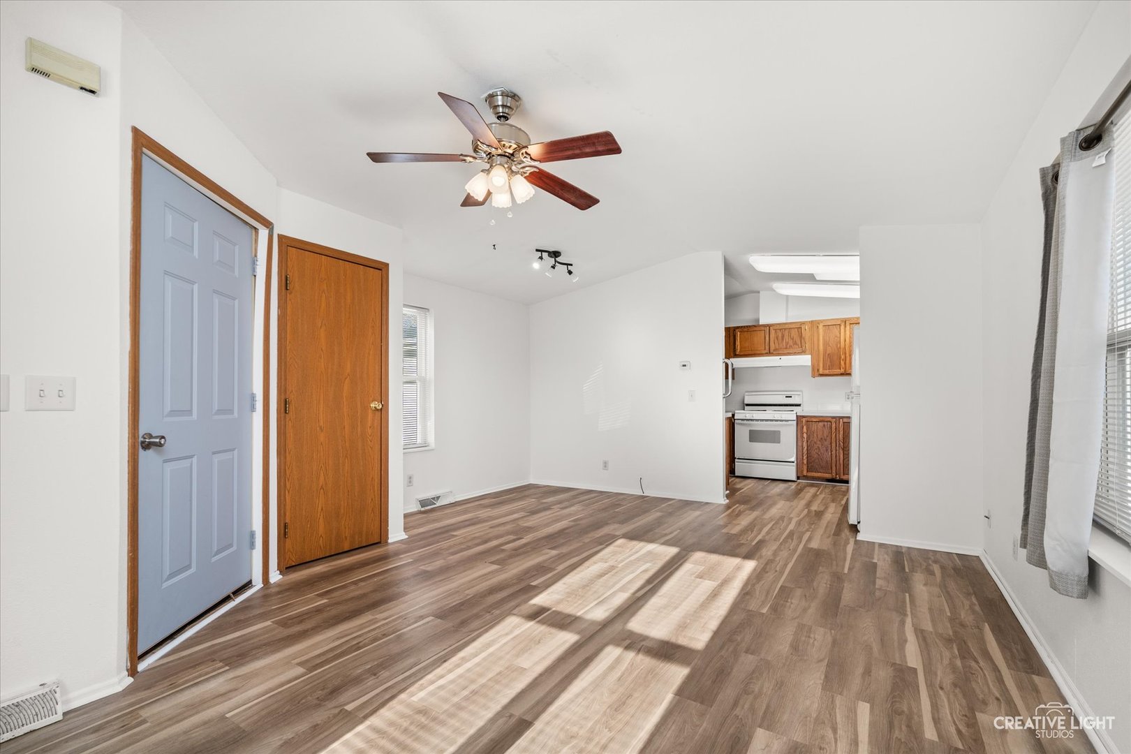 120 B Cardinal Lane Sandwich, IL 60548 - Photo 3 of 15 a view of empty room with wooden floor and fan