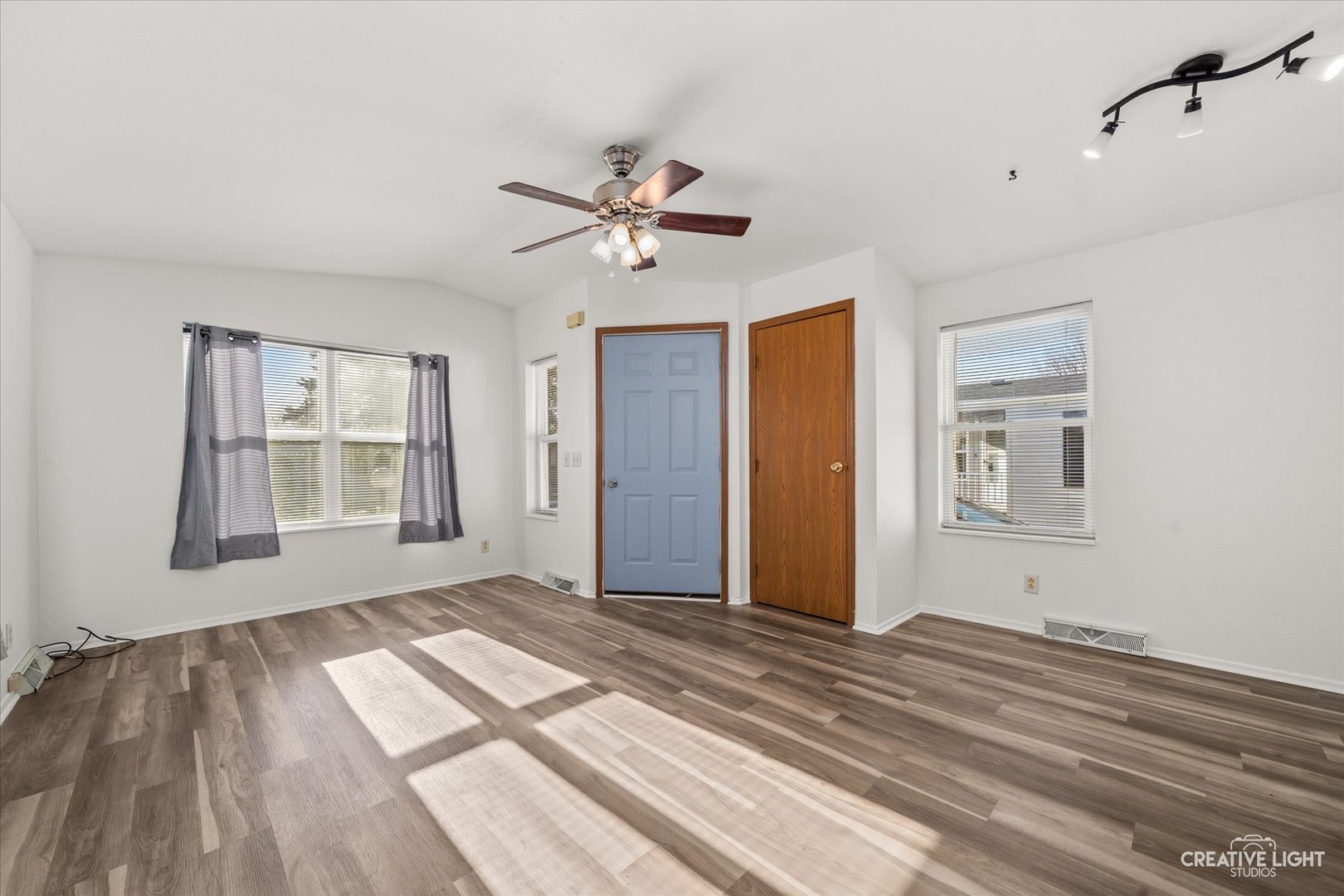 120 B Cardinal Lane Sandwich, IL 60548 - Photo 4 of 15 a view of empty room with wooden floor and fan