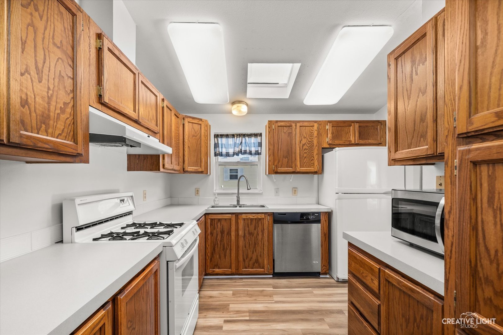 120 B Cardinal Lane Sandwich, IL 60548 - Photo 8 of 15 a kitchen with stainless steel appliances a stove a sink dishwasher and a refrigerator