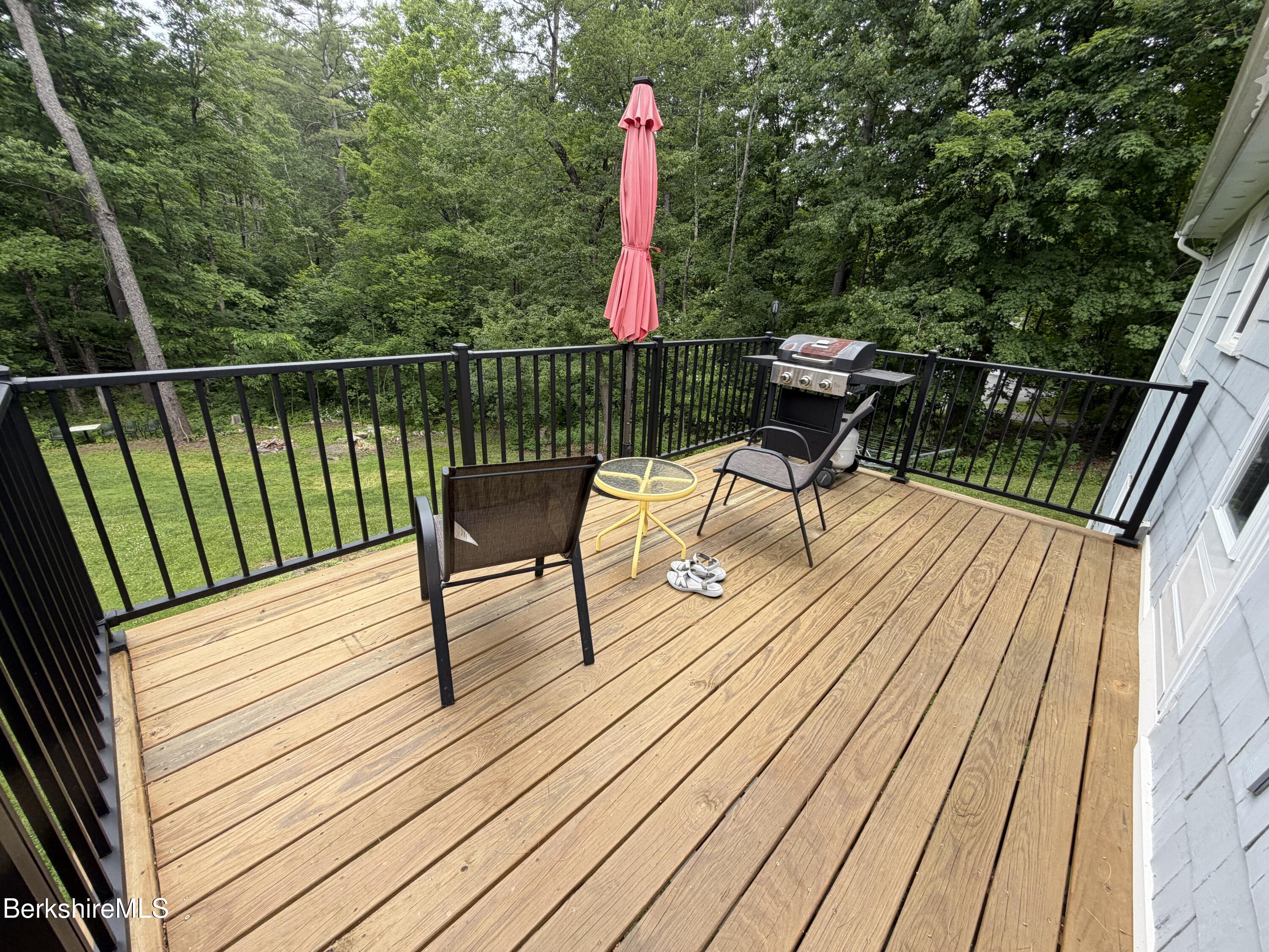 20 Sullivan Lane Lenox, MA 01240 - Photo 20 of 23 a view of a deck with wooden floor and outdoor seating