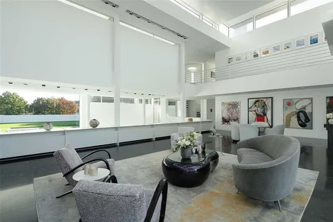 a living room with fireplace furniture and a large window