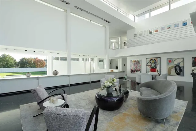 a living room with fireplace furniture and a large window