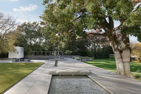 a balcony with wooden floor table and chairs