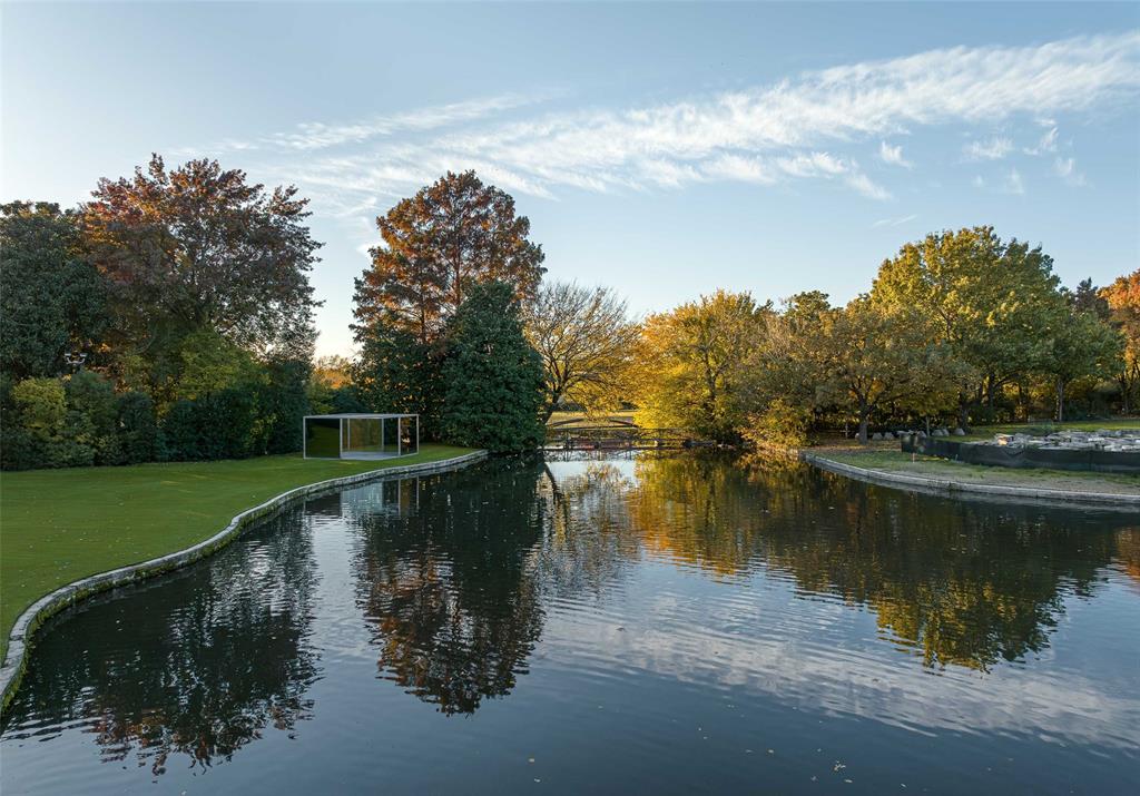 8605 Preston Road Dallas, TX 75225 - Photo 35 of 40 a view of a lake with a yard and large trees