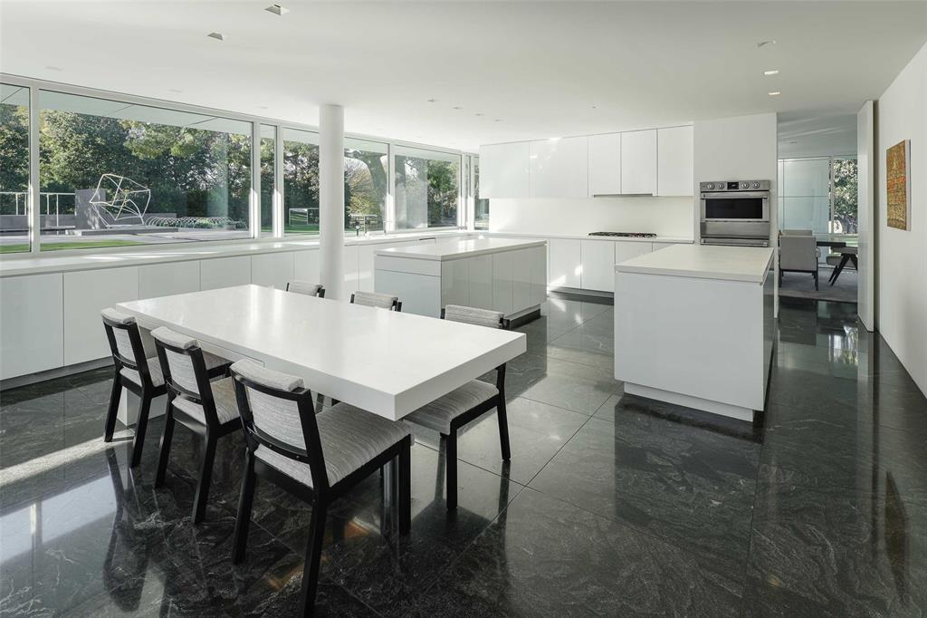 8605 Preston Road Dallas, TX 75225 - Photo 7 of 40 a kitchen with a table chairs sink and cabinets