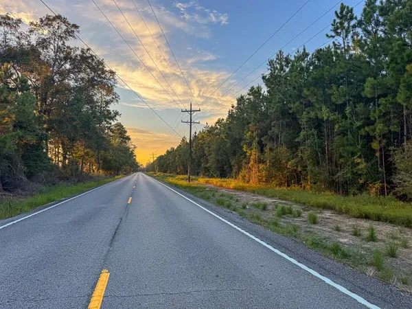 a view of a yard and basketball court