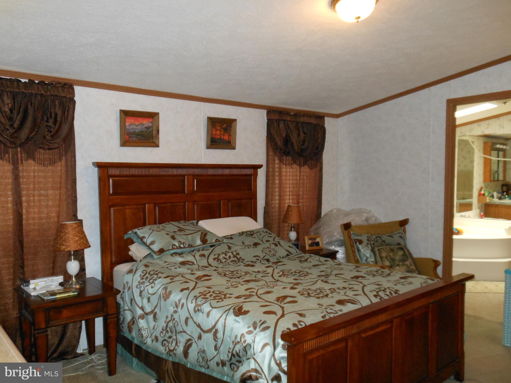 4550 Bull Road Dover, PA 17315 - Photo 9 of 14 a bedroom with a bed and a table in it
