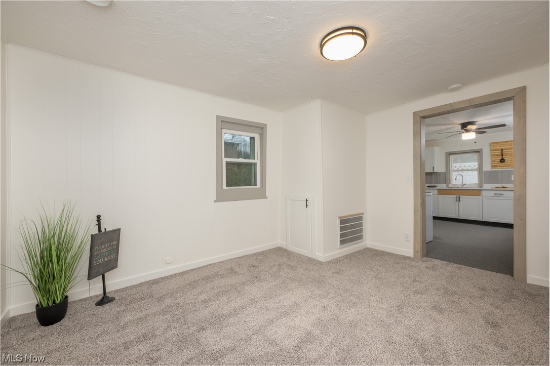 6273-6275 Manchester Road Clinton, OH 44216 - Photo 21 of 27 Unfurnished bedroom featuring light carpet and sink