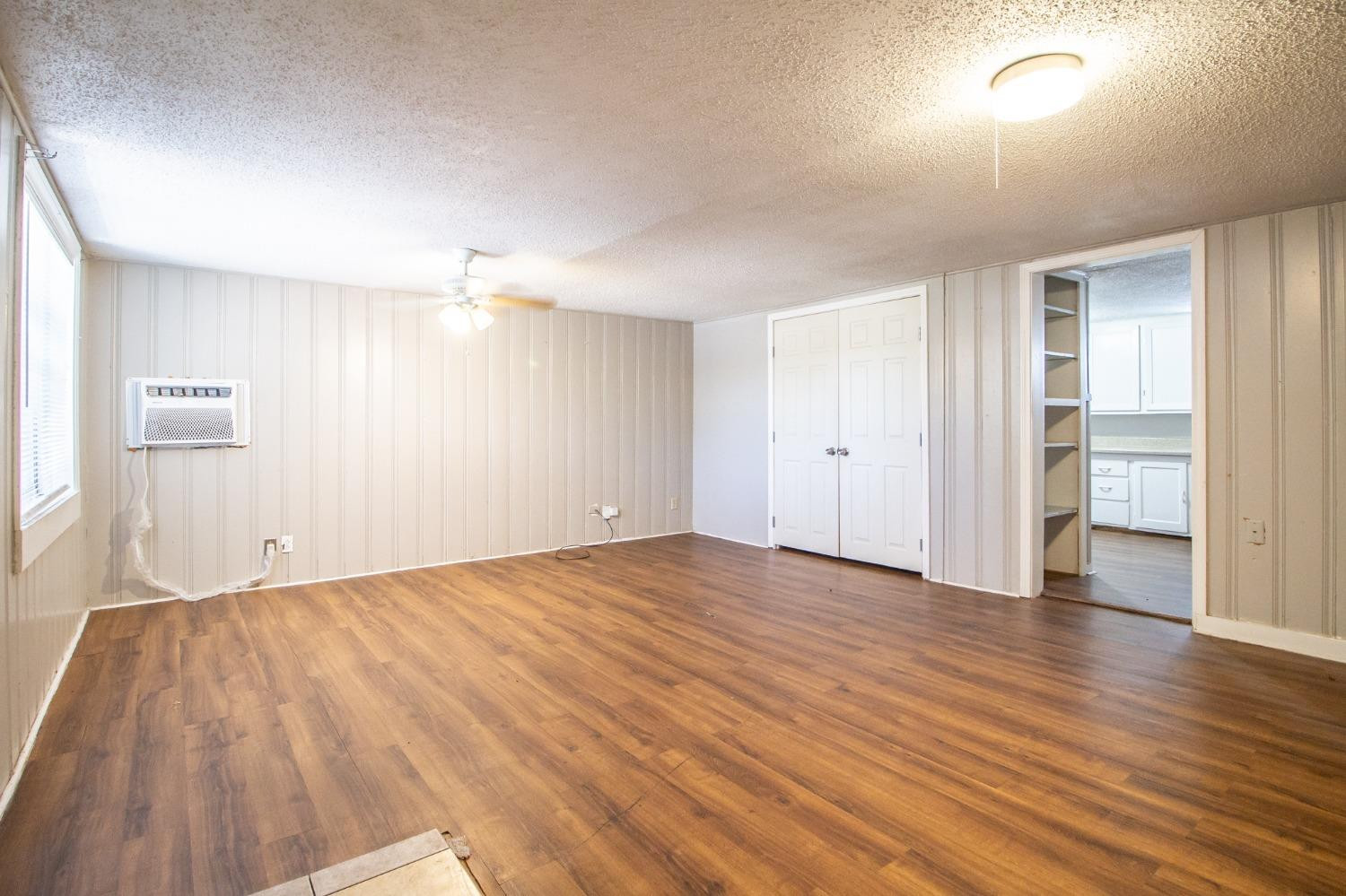 2429 27th Street Lubbock, TX 79411 - Photo 2 of 16 wooden floor in an empty room with a window