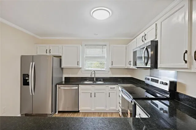 a kitchen with a sink stove and refrigerator