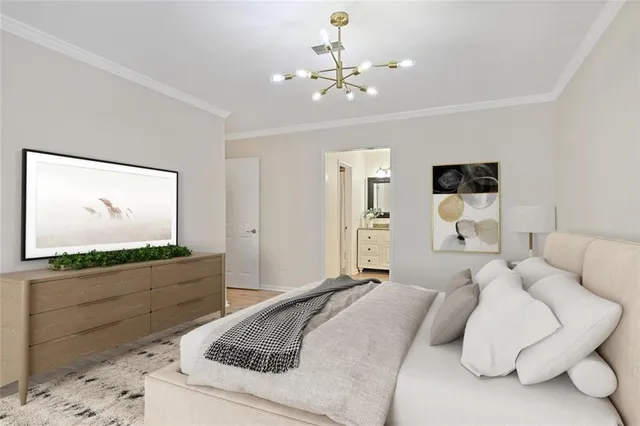 a spacious bedroom with a bed and a flat screen tv