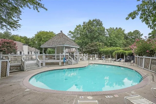 a view of a house with swimming pool and sitting area