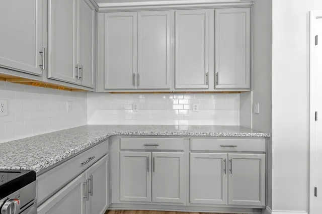 a kitchen with granite countertop white cabinets and a granite counter tops