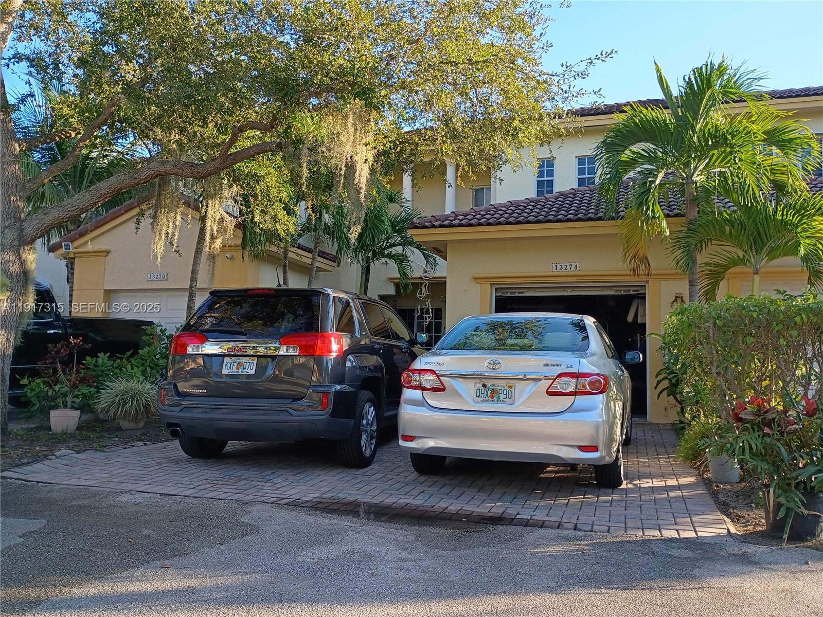 13274 Southwest 142nd Terrace, Unit 13274 Miami, FL 33186 - Photo 1 of 32 a white car parked in front of a house