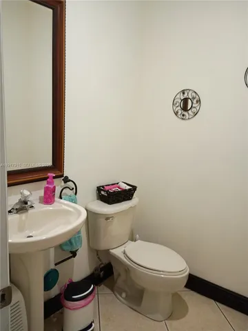 a white toilet sitting next to a bathroom sink