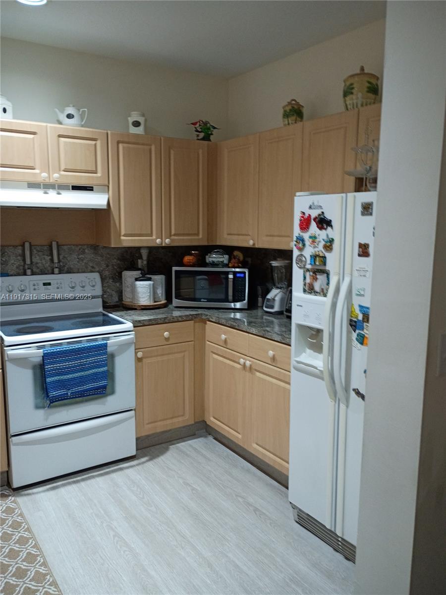 13274 Southwest 142nd Terrace, Unit 13274 Miami, FL 33186 - Photo 13 of 32 a kitchen with appliances a sink and cabinets