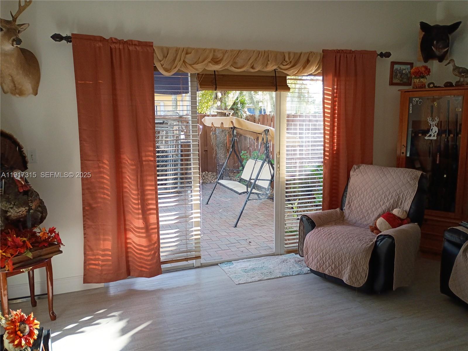13274 Southwest 142nd Terrace, Unit 13274 Miami, FL 33186 - Photo 17 of 32 a living room with furniture and a large window