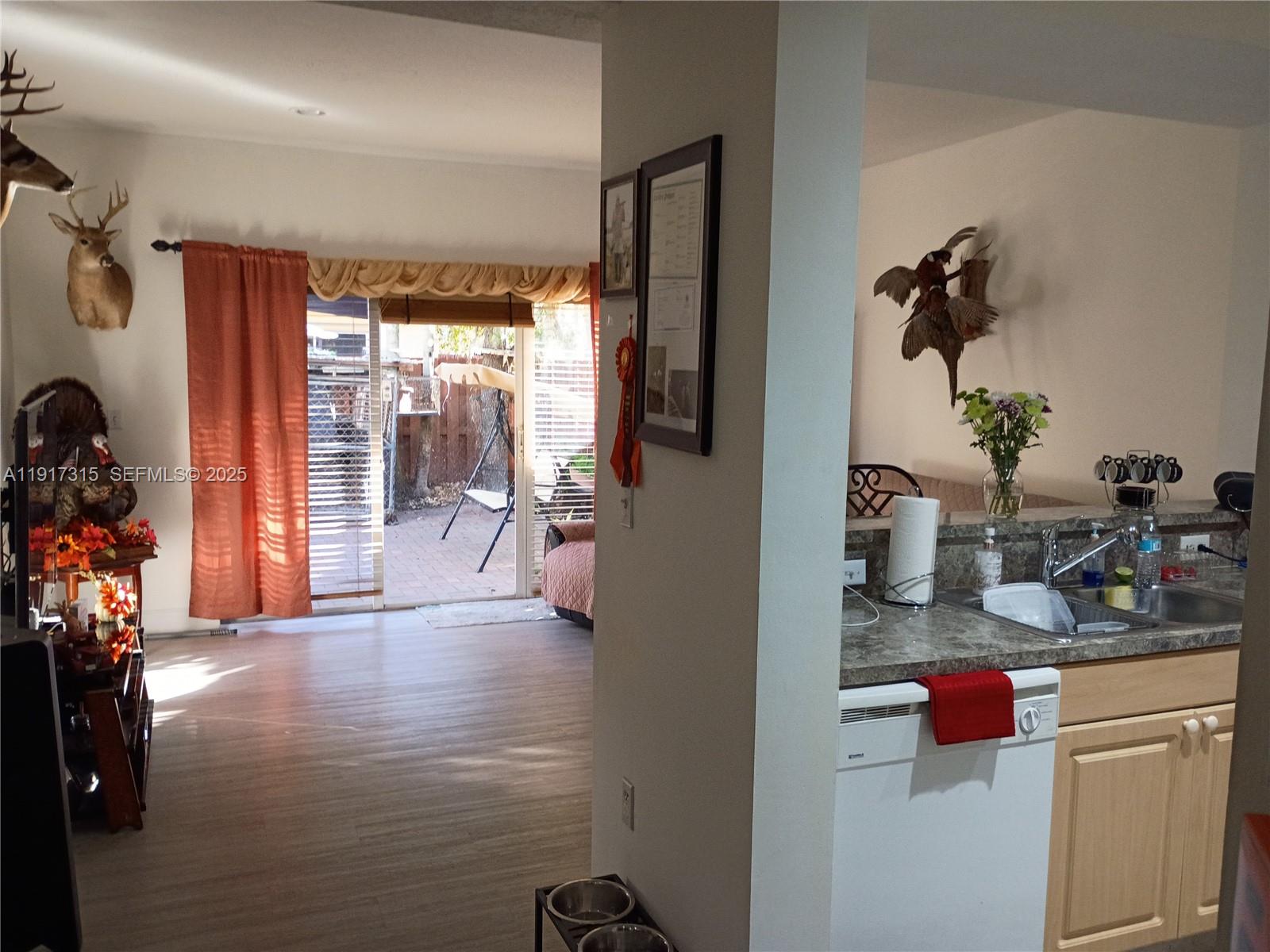 13274 Southwest 142nd Terrace, Unit 13274 Miami, FL 33186 - Photo 19 of 32 a kitchen with a refrigerator and a sink