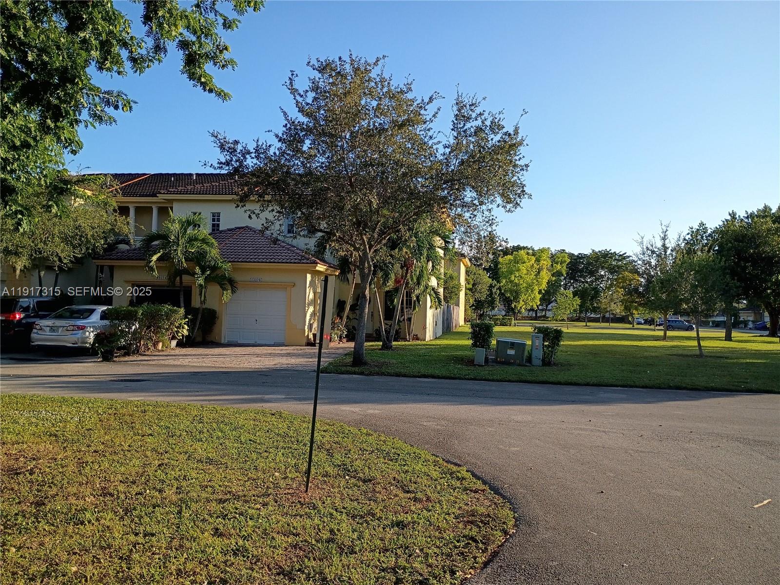 13274 Southwest 142nd Terrace, Unit 13274 Miami, FL 33186 - Photo 2 of 32 a view of a house with a yard and tree s