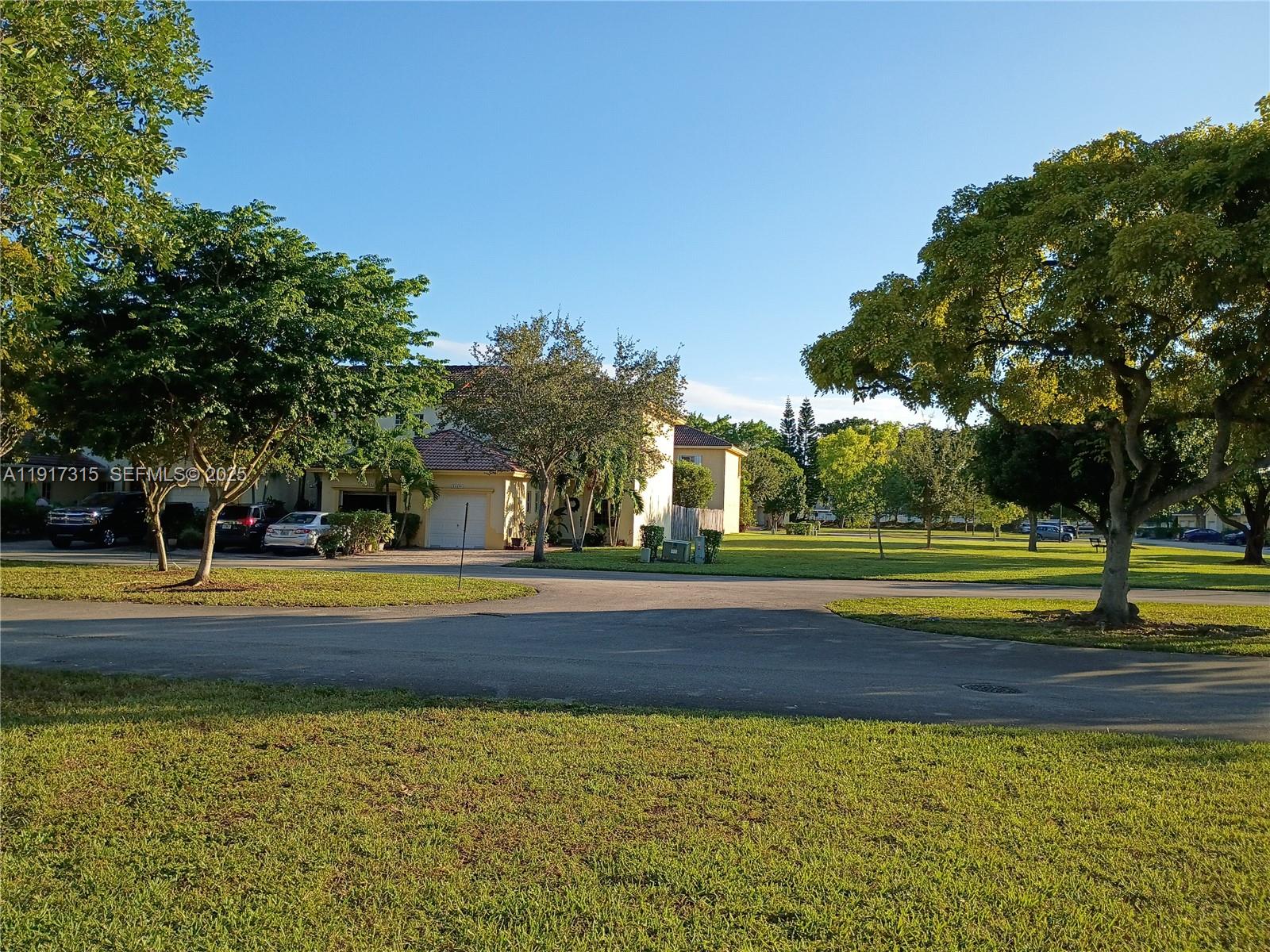 13274 Southwest 142nd Terrace, Unit 13274 Miami, FL 33186 - Photo 24 of 32 a view of swimming pool with trees in the background