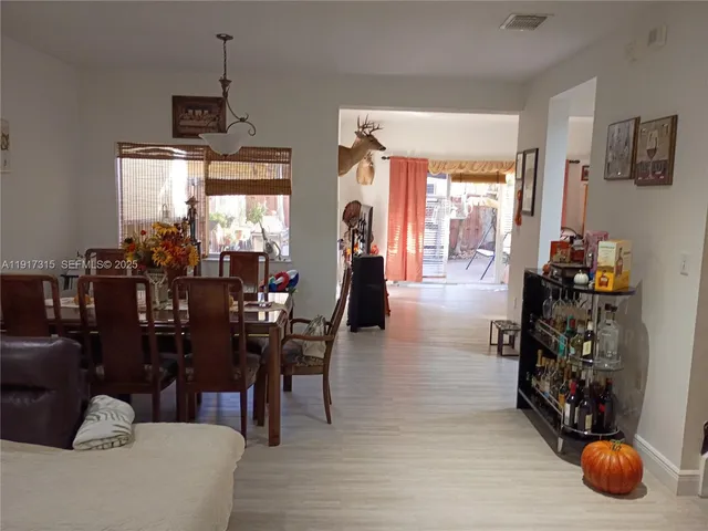 a dining room with furniture and window