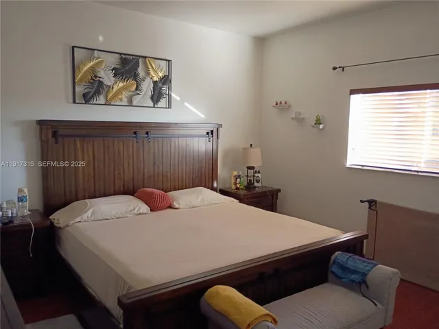 a bedroom with a bed and window