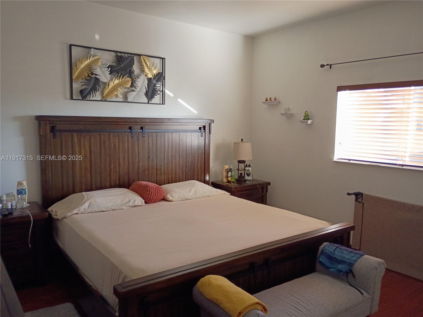 13274 Southwest 142nd Terrace, Unit 13274 Miami, FL 33186 - Photo 28 of 32 a bedroom with a bed and window