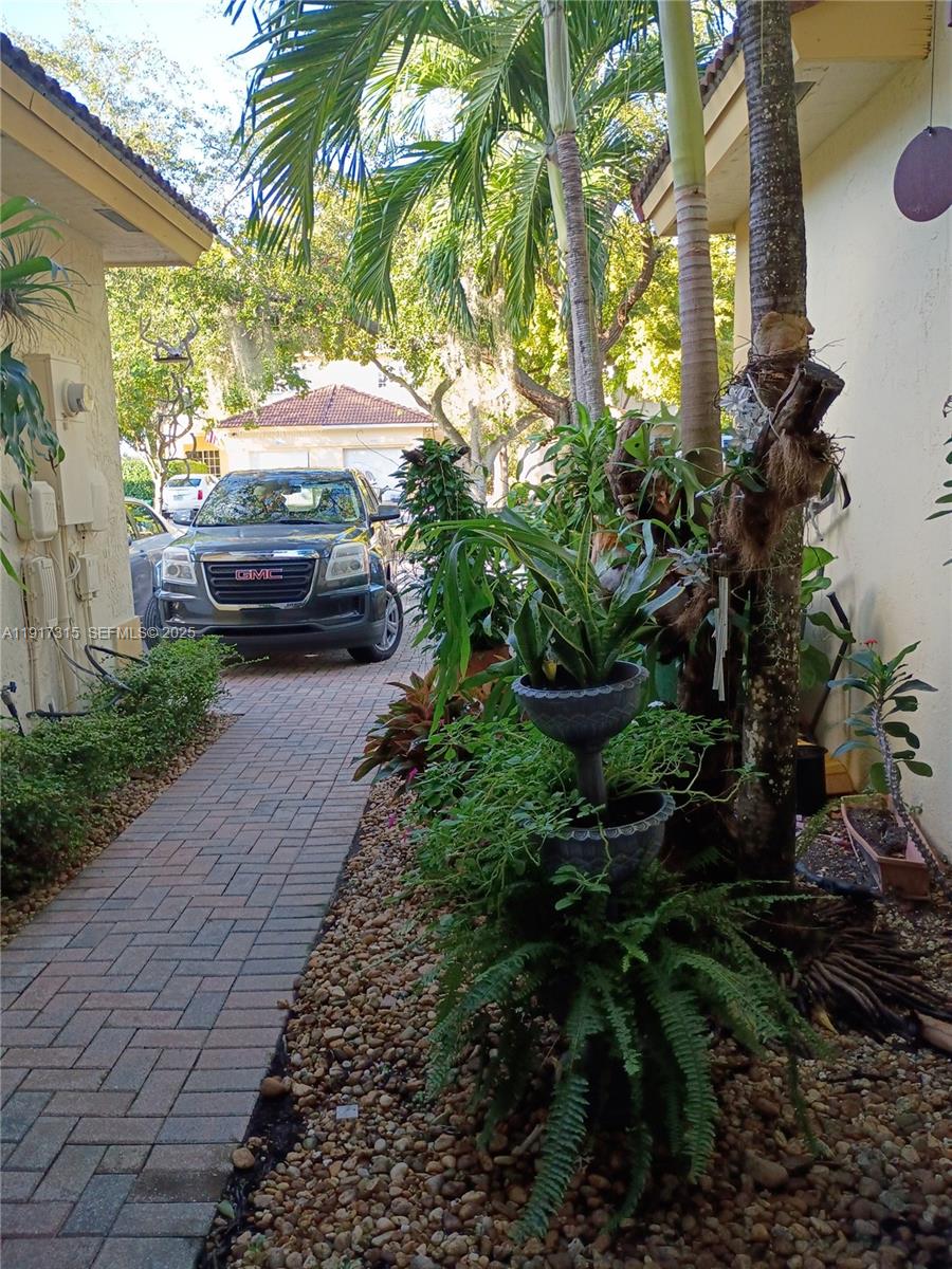 13274 Southwest 142nd Terrace, Unit 13274 Miami, FL 33186 - Photo 29 of 32 a view of a garden with a car parked