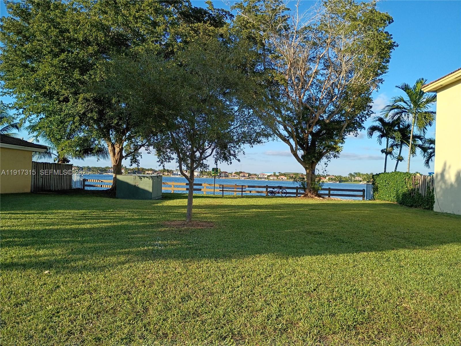 13274 Southwest 142nd Terrace, Unit 13274 Miami, FL 33186 - Photo 4 of 32 a view of a park that has a large tree