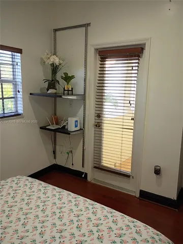 a room with a window and wooden floor