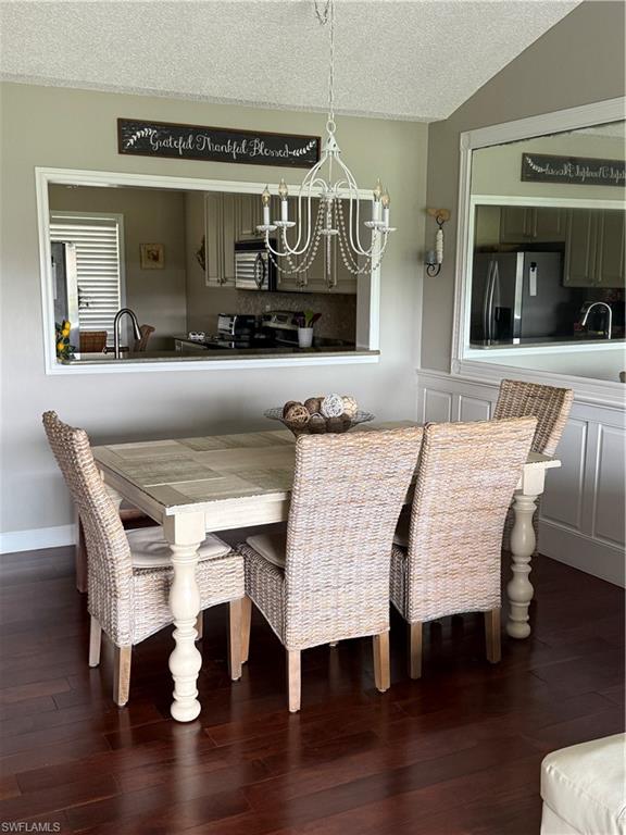 760 Augusta Boulevard, Unit D204 Naples, FL 34113 - Photo 25 of 32 a living room with a table and chairs