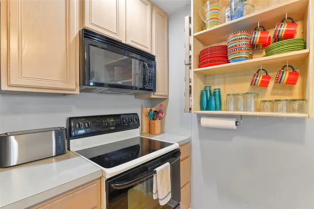 a kitchen with stainless steel appliances granite countertop a stove and a microwave