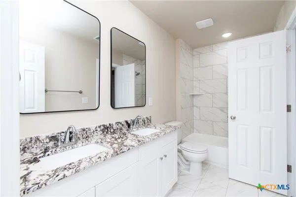 an empty room with wooden floor and window