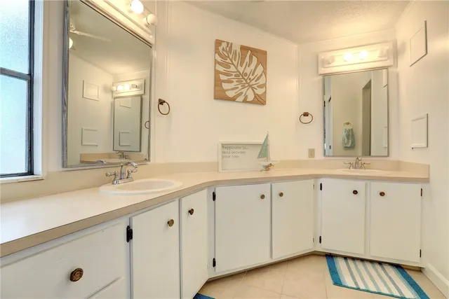 a bathroom with a granite countertop sink a toilet and a mirror