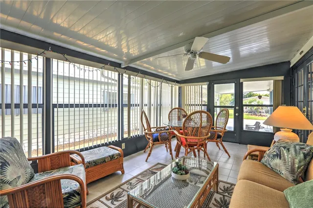 an aerial view of a house with a swimming pool and outdoor seating